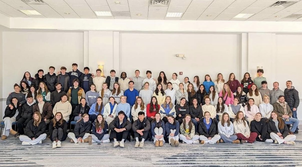 Tatum with a large group of students at a school event, arranged in rows for a group photo