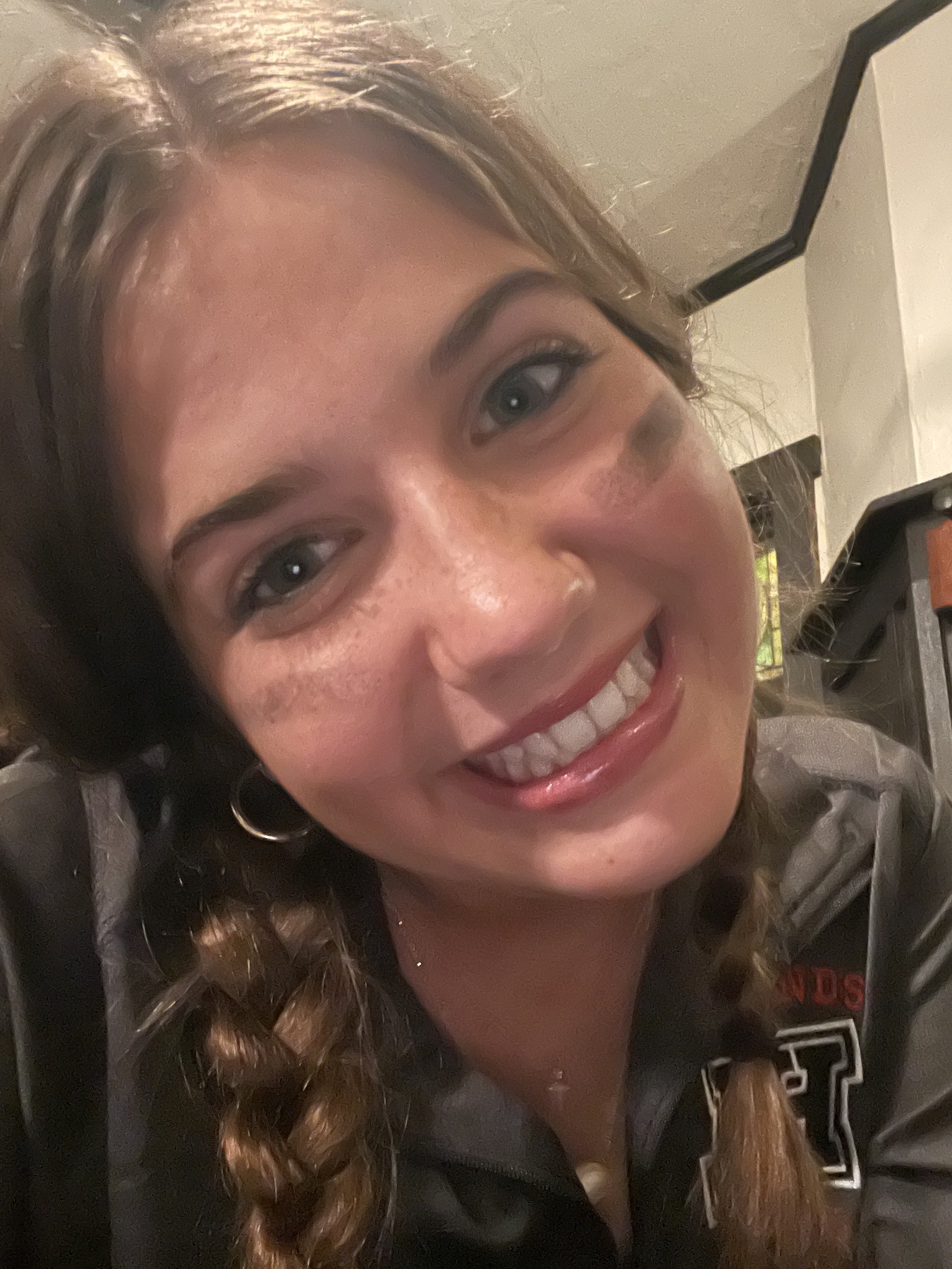 Tatum smiling at the camera with eye black on her cheeks