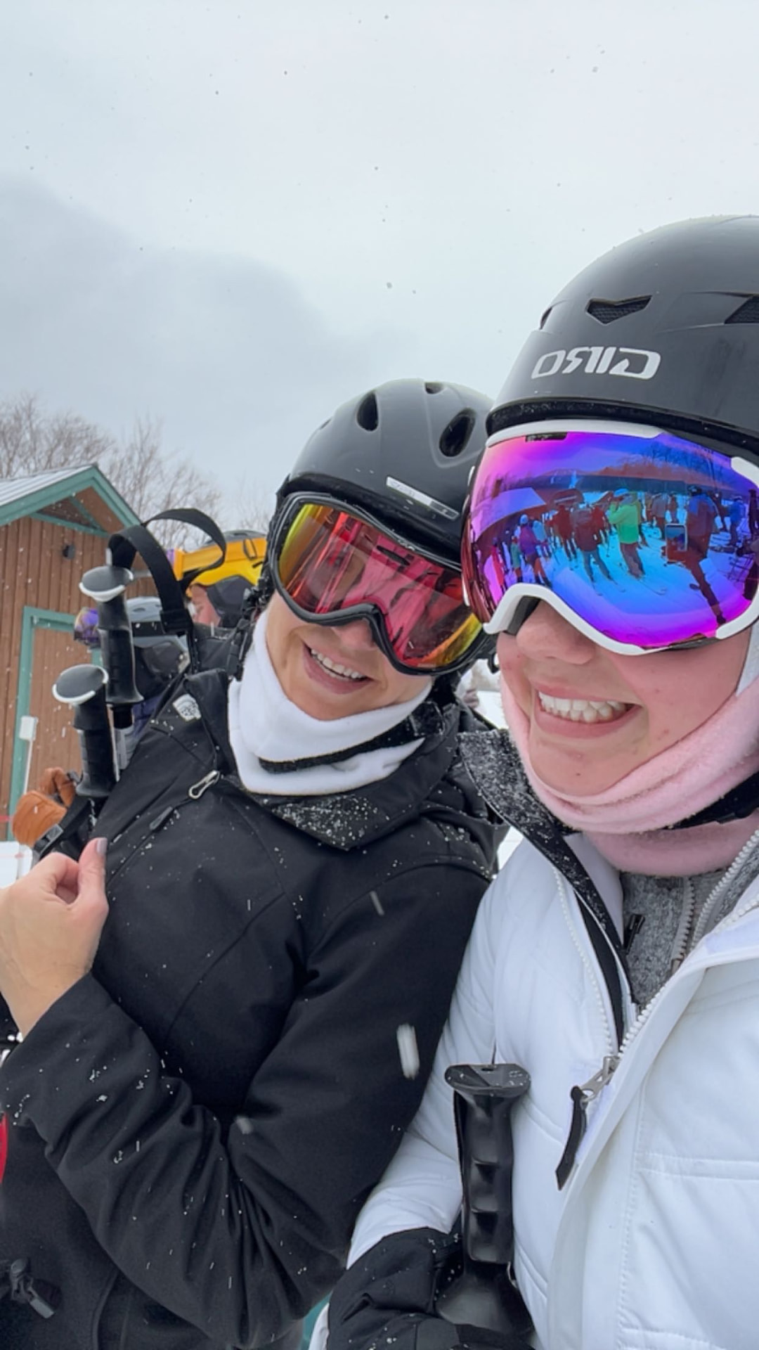 Tatum and a friend in helmets and goggles on the ski slope